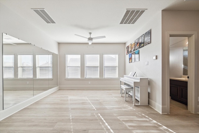 office featuring visible vents, baseboards, a ceiling fan, and wood finished floors