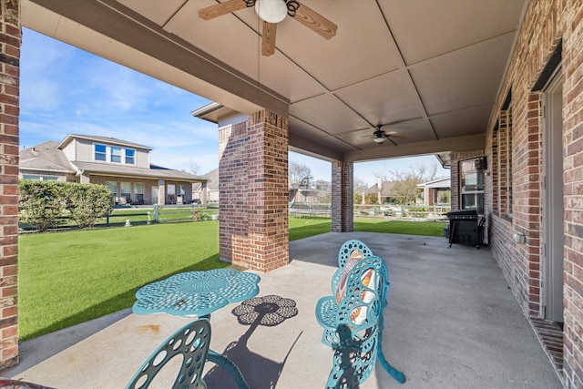 view of patio / terrace featuring a carport and ceiling fan