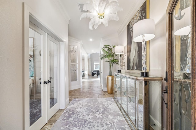 hallway featuring visible vents, crown molding, baseboards, a chandelier, and french doors