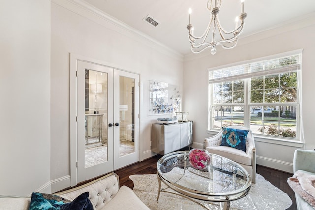 sitting room with visible vents, ornamental molding, dark wood-type flooring, french doors, and a notable chandelier