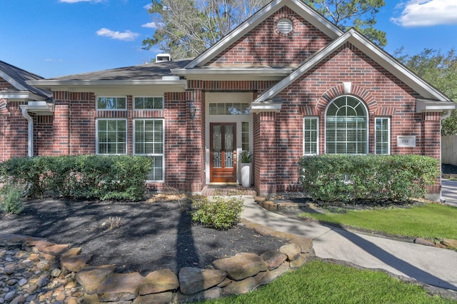 view of front of house featuring french doors and brick siding