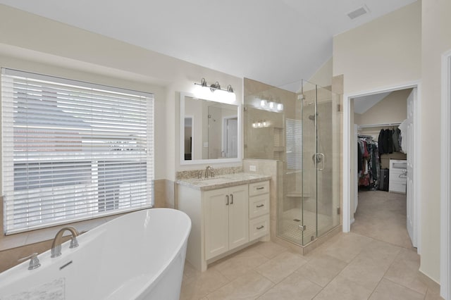 full bath with visible vents, a stall shower, a soaking tub, vanity, and vaulted ceiling