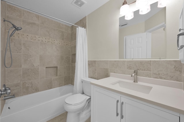 full bathroom with vanity, visible vents, tile walls, toilet, and shower / tub combo with curtain