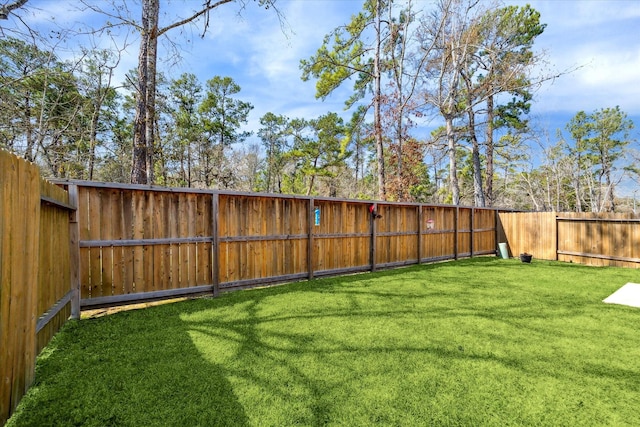 view of yard with a fenced backyard