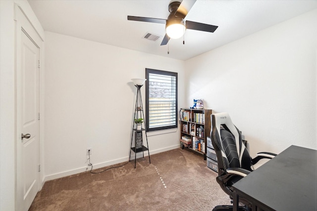 office featuring visible vents, carpet floors, baseboards, and a ceiling fan