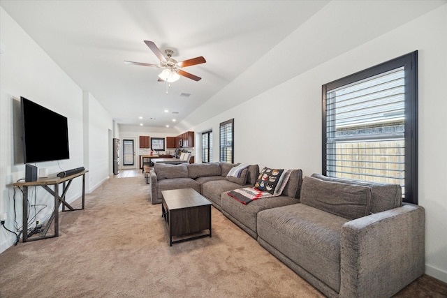 living room featuring recessed lighting, light colored carpet, baseboards, and ceiling fan