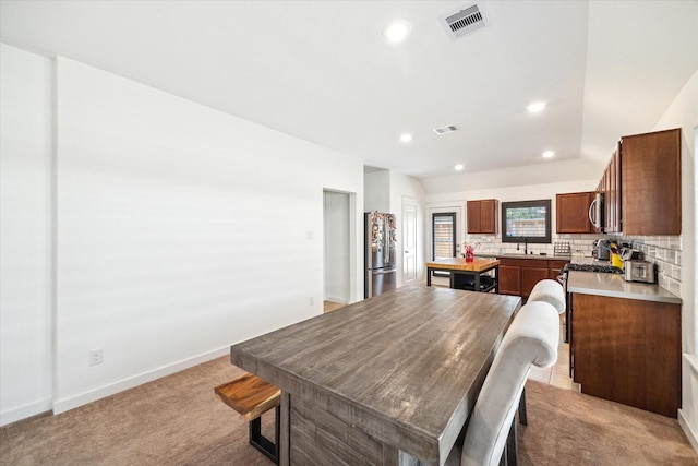 dining room with baseboards, recessed lighting, visible vents, and light carpet