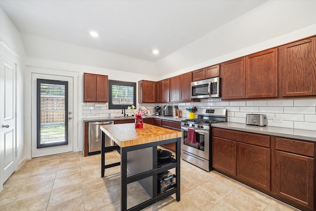 kitchen with backsplash, recessed lighting, appliances with stainless steel finishes, light countertops, and light tile patterned floors