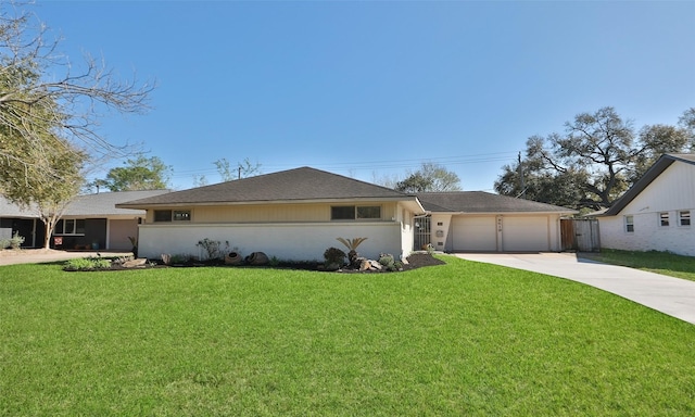 view of front of property featuring a garage, stucco siding, driveway, and a front lawn