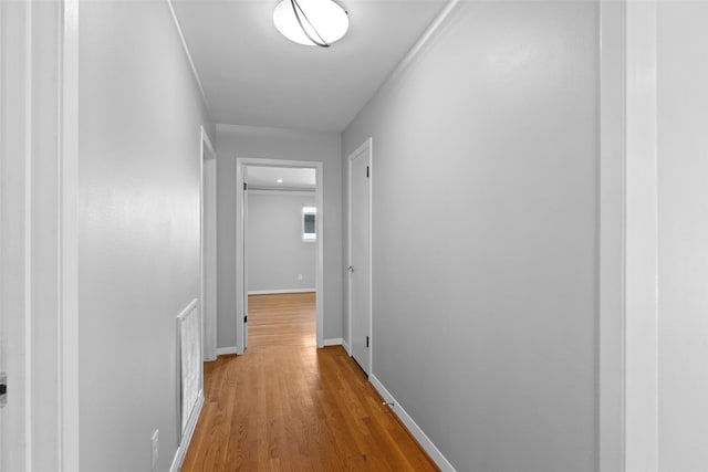 hallway with baseboards and wood finished floors