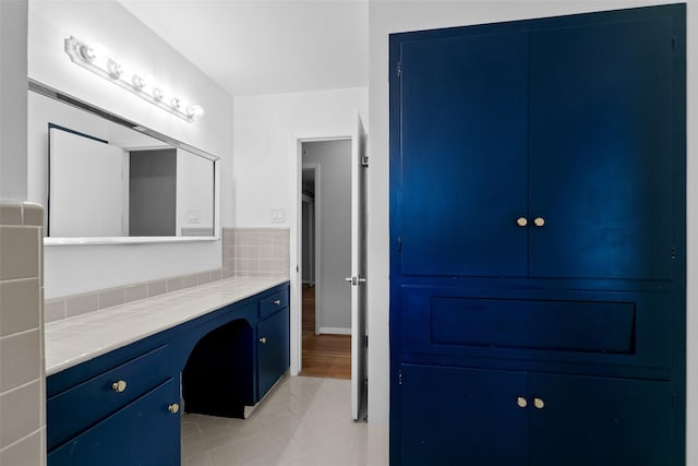 bathroom featuring tile patterned flooring and vanity