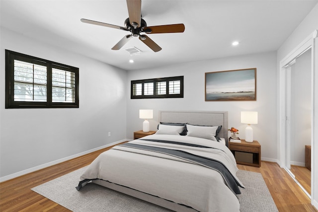 bedroom with visible vents, a ceiling fan, recessed lighting, light wood-style floors, and baseboards