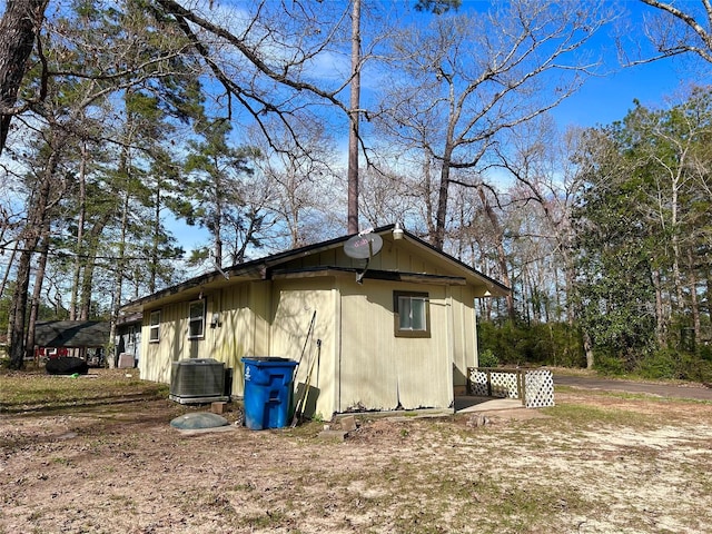 view of side of home featuring central AC