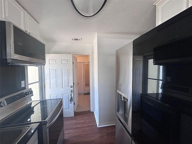 kitchen with dark wood finished floors, visible vents, white cabinets, and stainless steel electric range