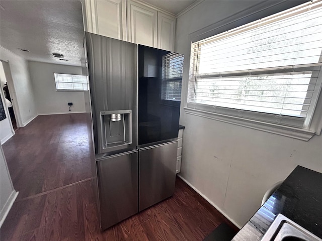 kitchen featuring stainless steel refrigerator with ice dispenser, wood finished floors, baseboards, and a textured ceiling