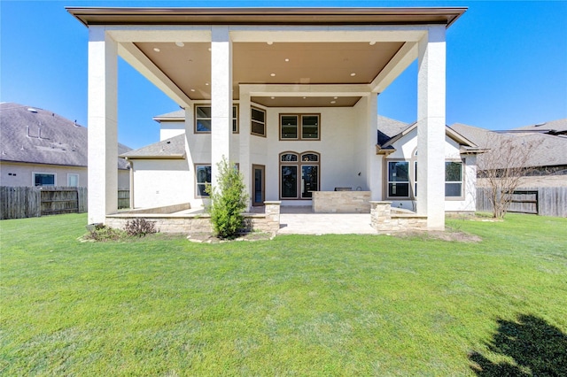 rear view of house with a yard, fence, and a patio area