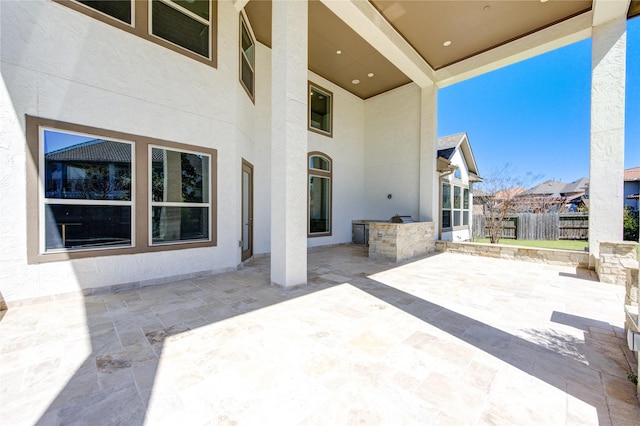 view of patio featuring fence