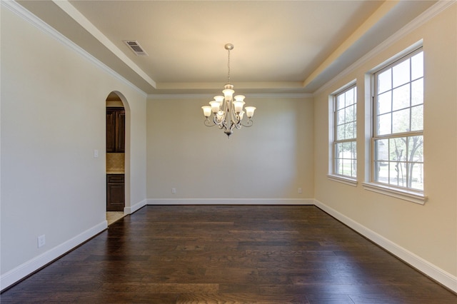 empty room featuring visible vents, arched walkways, a raised ceiling, and dark wood-type flooring