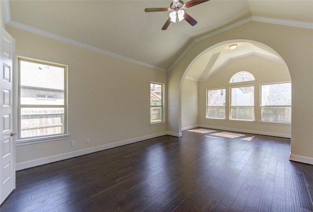 spare room with arched walkways, dark wood-type flooring, lofted ceiling, and ceiling fan