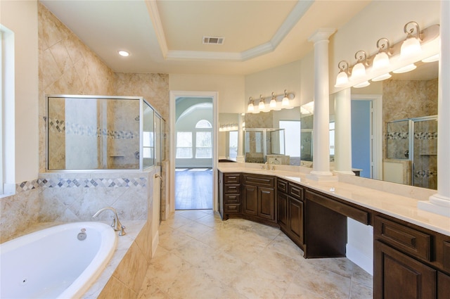 bathroom with a garden tub, ornate columns, a shower stall, crown molding, and a raised ceiling