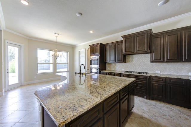 kitchen featuring ornamental molding, tasteful backsplash, stainless steel appliances, and a chandelier