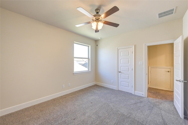 unfurnished bedroom featuring a ceiling fan, baseboards, visible vents, and carpet floors