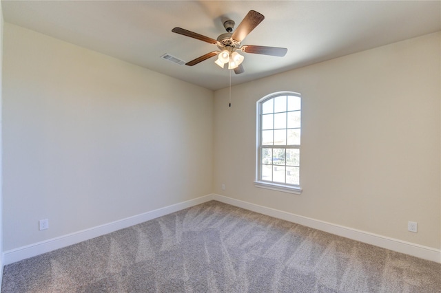 unfurnished room featuring baseboards, visible vents, and light carpet