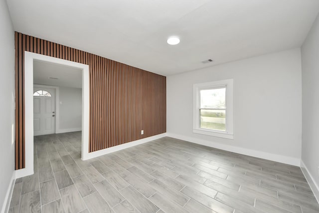 unfurnished room featuring visible vents, baseboards, and light wood-style flooring