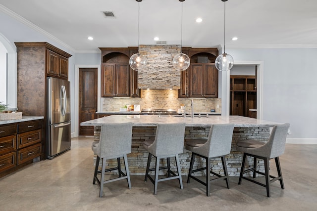 kitchen featuring backsplash, concrete floors, and freestanding refrigerator