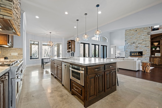 kitchen featuring backsplash, finished concrete flooring, dark brown cabinetry, stainless steel appliances, and a sink