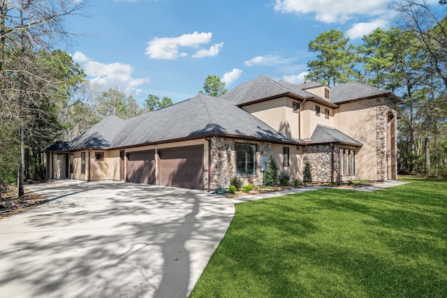 view of front facade with an attached garage, stucco siding, a front lawn, concrete driveway, and stone siding