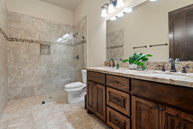 bathroom with double vanity, toilet, walk in shower, and a sink