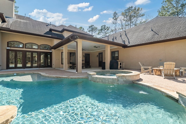 view of swimming pool featuring a patio, a pool with connected hot tub, a ceiling fan, and french doors