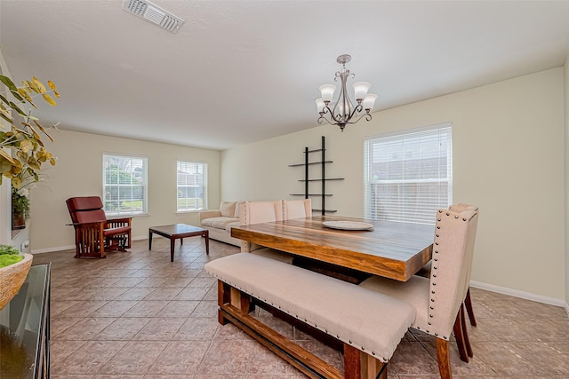 dining area with visible vents, baseboards, and a notable chandelier