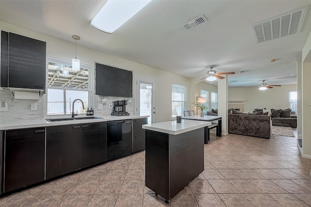 kitchen with visible vents, a sink, light countertops, dishwasher, and dark cabinets