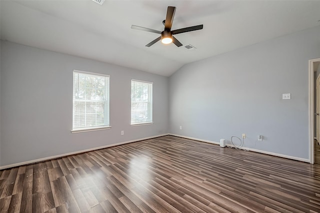 spare room featuring visible vents, baseboards, ceiling fan, lofted ceiling, and wood finished floors