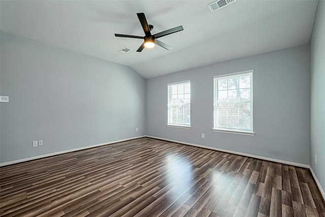 unfurnished room with dark wood finished floors, visible vents, lofted ceiling, and a ceiling fan