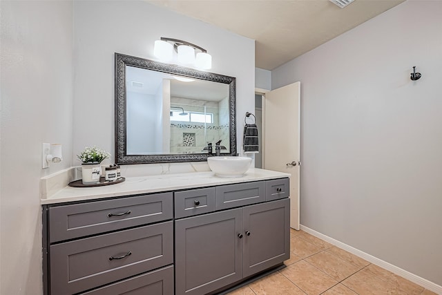 bathroom with vanity, tile patterned floors, and baseboards