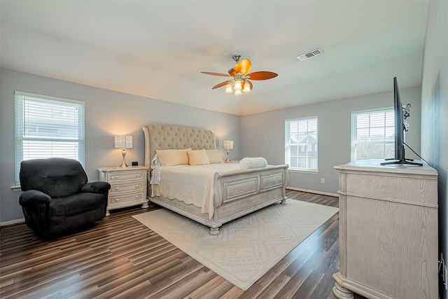 bedroom featuring visible vents, baseboards, and dark wood-type flooring