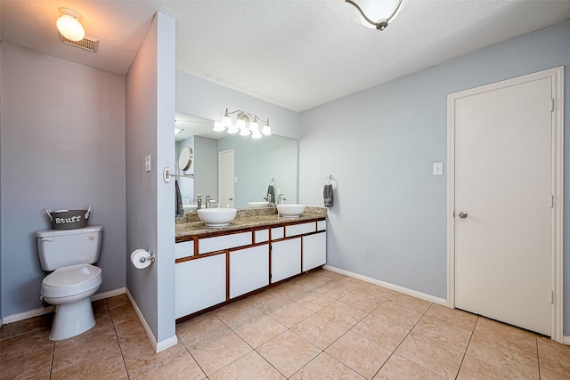 full bathroom with a sink, visible vents, toilet, and tile patterned floors