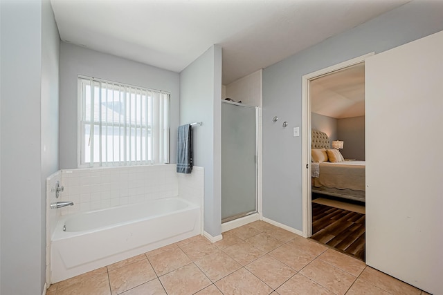 ensuite bathroom with a shower stall, tile patterned floors, and ensuite bathroom