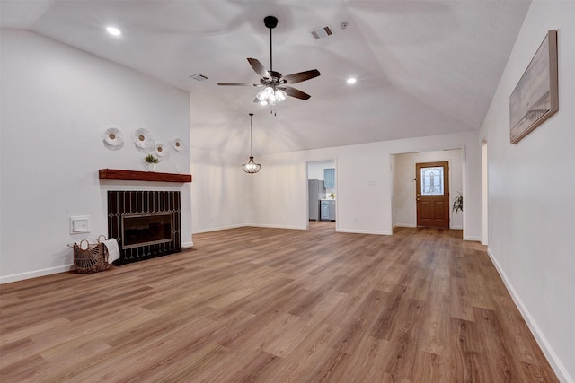 unfurnished living room featuring visible vents, lofted ceiling, ceiling fan, and light wood finished floors