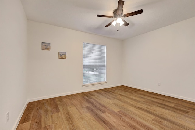 empty room with light wood-type flooring, baseboards, and ceiling fan