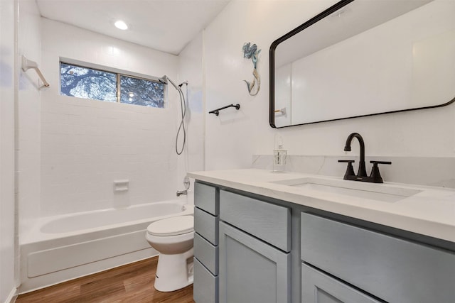 full bathroom with vanity, toilet, wood finished floors, and bathtub / shower combination