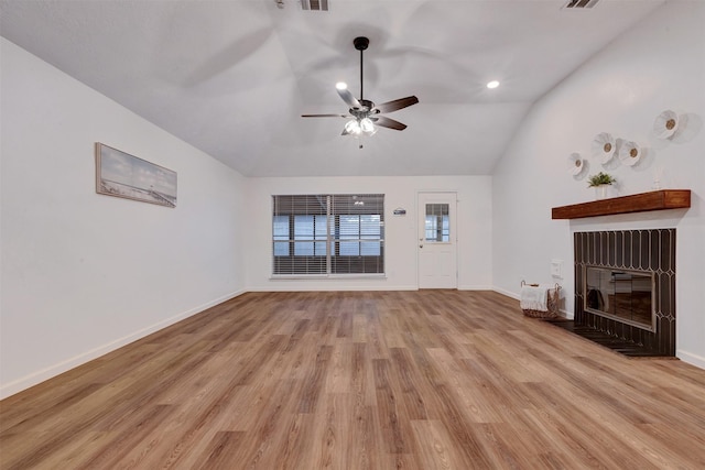 unfurnished living room with baseboards, light wood-style flooring, a fireplace with flush hearth, ceiling fan, and vaulted ceiling