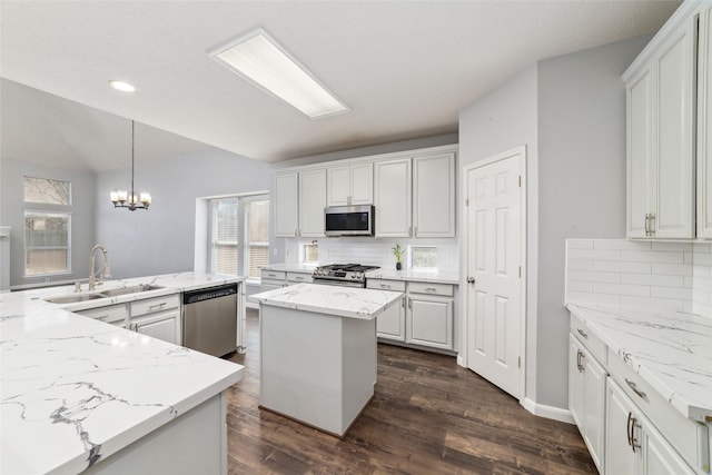 kitchen featuring white cabinetry, a center island with sink, appliances with stainless steel finishes, and a sink