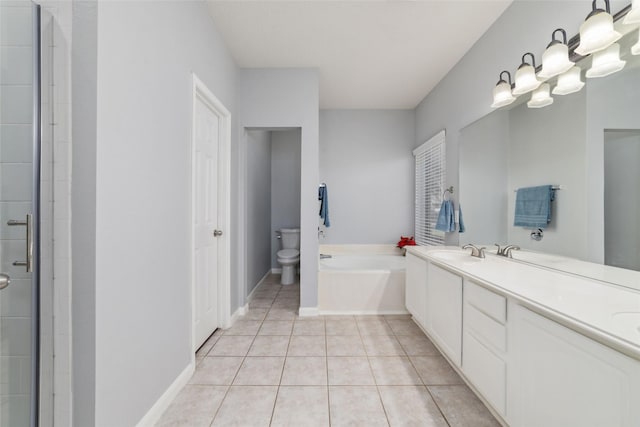 full bathroom with baseboards, toilet, a bath, tile patterned floors, and vanity