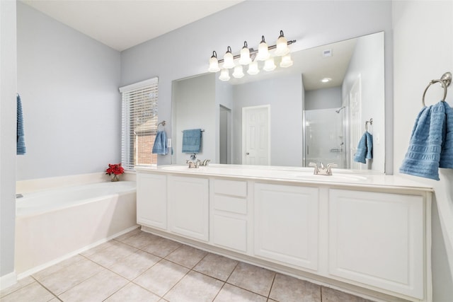 full bathroom featuring tile patterned floors, a garden tub, a stall shower, and a sink