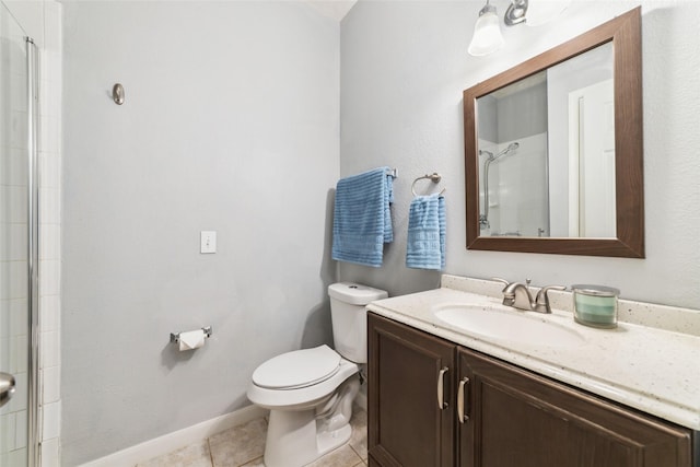 bathroom featuring tile patterned flooring, baseboards, walk in shower, toilet, and vanity