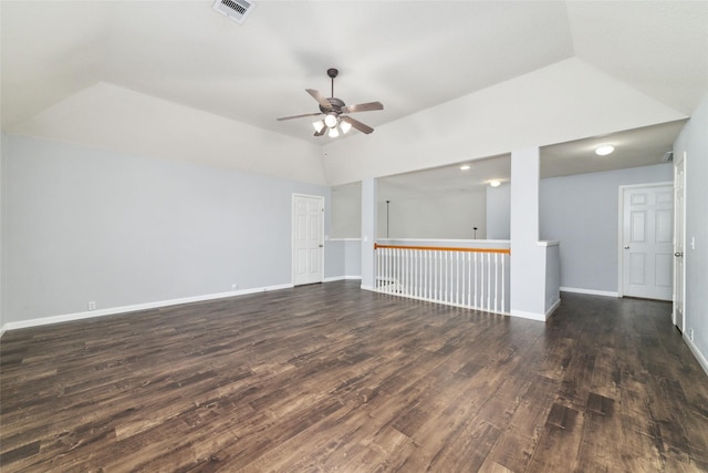 spare room with a ceiling fan, visible vents, baseboards, dark wood-style flooring, and vaulted ceiling